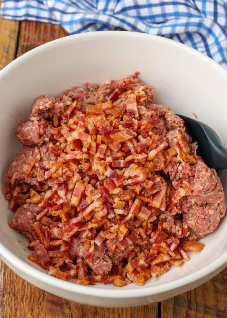 ground beef and bacon in large mixing bowl for meatloaf