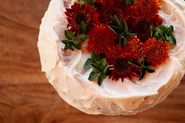 frosted carrot cake topped with flowers