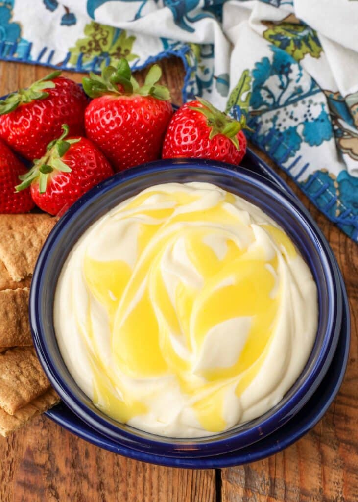 creamy fruit dip with lemon curd swirl in bowl with strawberries