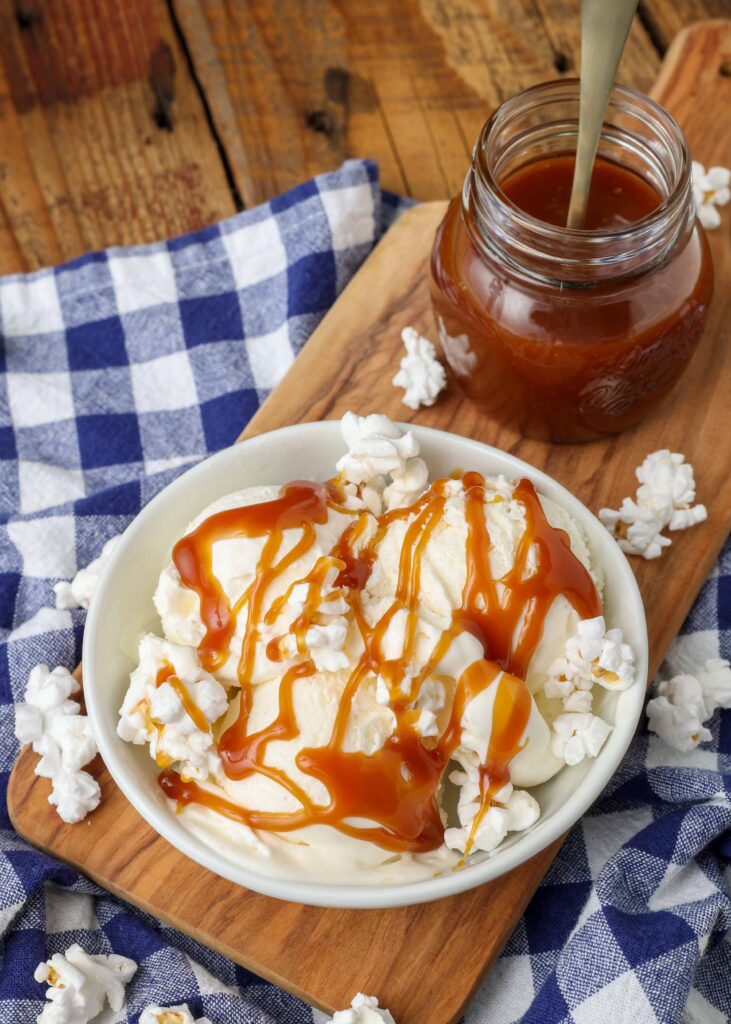 caramel sauce has been drizzled over three scoops of popcorn ice cream in this photo