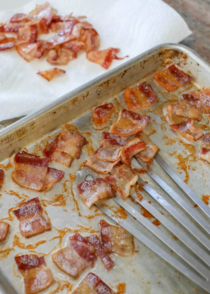 Partially cooked bacon on roasting pan
