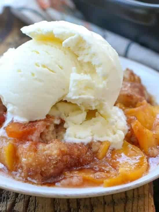 Peach Cobbler is the quintessential summer dessert with juicy peaches and a flaky buttery biscuit-like topping sprinkled generously with cinnamon and sugar!